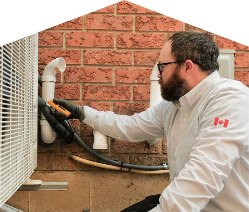 Romaniuk HVAC specialist checking insulated piping on a heat pump unit beside a brick wall during a diagnostic service. Romaniuk HVAC specialist checking insulated piping on a heat pump unit beside a brick wall during a diagnostic service.